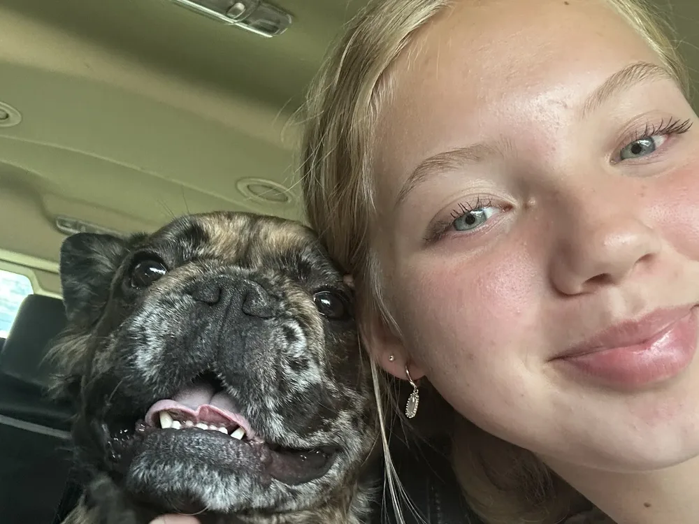 Melody's daughter with a dog during a transport ride
